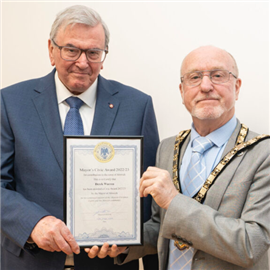 Derek Warren (left) receiving an award from the Mayor of Alnwick 