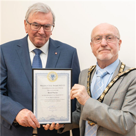 Derek Warren (left) receiving an award from the Mayor of Alnwick