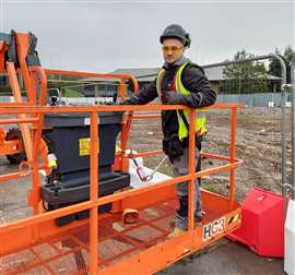 An operator inside the basket of a MEWP wearing the Harness On safety system