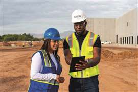 Photo shows a United Rentals employee on site with a customer, looking at a mobile device.. The company has launched two new digital tools. (Photo: United Rentals)