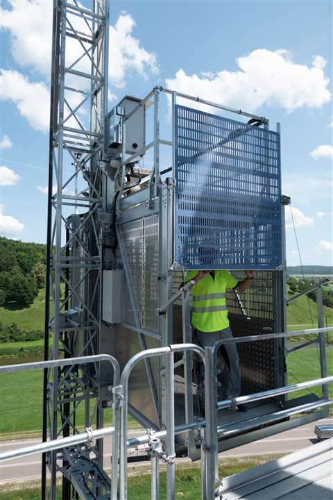 A construction worker exiting the GEDA BL 2000 hoist