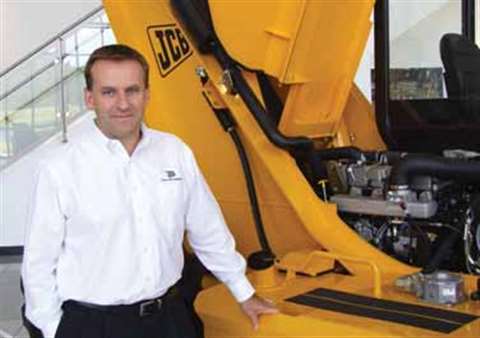 JCB Inc. – The Americas' President Graeme Macdonald stands in front of a Loadall model in the compan