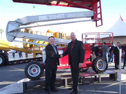 MEC president David White (left) stands in front of the company's 3084RT sigma lift with MEC's Jim T