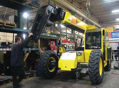 Fitting the boom onto a ZoomBoom 8044 machine at Carelift's Breslau, Ontario facility. Production wi