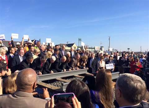 California state Governor Edmund G. Brown Jr. and other dignitaries sign a ceremonial rail at the Fr
